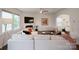 Bright living room features a fireplace, tv, neutral sofa, and large windows at 17812 New Mark Ave, Charlotte, NC 28278