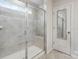 Walk-in tiled shower with glass door and built-in bench at 17812 New Mark Ave, Charlotte, NC 28278