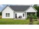 The home's rear view reveals a patio with a grill and seating area, ideal for outdoor dining at 182 Mackenzie Ct, China Grove, NC 28023