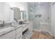 Bright bathroom with double vanity, granite counters, and spacious glass enclosed shower at 182 Mackenzie Ct, China Grove, NC 28023