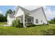 Lush landscaping surrounds the home's screened porch and patio, offering private outdoor spaces at 182 Mackenzie Ct, China Grove, NC 28023
