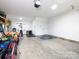 A brightly lit, spacious garage with concrete floors offers ample space for parking and storage at 182 Mackenzie Ct, China Grove, NC 28023