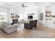 Bright living room with hardwood floors, fireplace, neutral decor, and tray ceiling at 182 Mackenzie Ct, China Grove, NC 28023