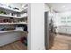 Well-stocked walk-in pantry with ample shelving, adjacent to the kitchen with stainless steel appliances at 182 Mackenzie Ct, China Grove, NC 28023