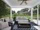 Relaxing screened-in porch featuring comfortable seating and views of the backyard at 182 Mackenzie Ct, China Grove, NC 28023