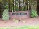 Entrance sign for Forest Abbey community, surrounded by lush greenery and landscaping at 182 Mackenzie Ct, China Grove, NC 28023