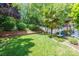 Beautiful backyard featuring a green lawn, mature landscaping, and a small fountain at 19539 Denae Lynn Dr, Cornelius, NC 28031