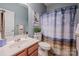 Bathroom boasting a stylish vanity, decorative mirror, and a shower with a patterned curtain at 19539 Denae Lynn Dr, Cornelius, NC 28031