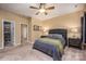 Comfortable bedroom featuring a ceiling fan, carpet, and a doorway to a walk-in closet at 19539 Denae Lynn Dr, Cornelius, NC 28031