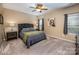 Comfortable bedroom featuring neutral tones, plush carpeting, and a ceiling fan for a relaxing ambiance at 19539 Denae Lynn Dr, Cornelius, NC 28031