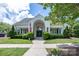 Beautiful clubhouse with a dark green double-door entry is framed by green trimmed windows and white columns at 19539 Denae Lynn Dr, Cornelius, NC 28031