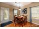 Cozy dining room with a wood table, seating for six, and ample natural light from the windows at 19539 Denae Lynn Dr, Cornelius, NC 28031
