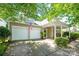 Charming home boasting a two-car garage and inviting covered front porch with cozy seating at 19539 Denae Lynn Dr, Cornelius, NC 28031