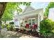 Home's inviting covered porch features cozy seating and a view of the manicured front yard at 19539 Denae Lynn Dr, Cornelius, NC 28031
