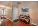Hallway with hardwood floors, neutral paint, and tasteful decor on a console table at 19539 Denae Lynn Dr, Cornelius, NC 28031