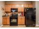 Bright kitchen with a sleek black refrigerator and wooden cabinets at 19539 Denae Lynn Dr, Cornelius, NC 28031