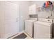 Practical laundry room equipped with a washer, dryer, and storage shelves for convenience at 19539 Denae Lynn Dr, Cornelius, NC 28031