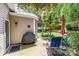 Cozy patio with seating, a grill, and a view of the landscaped backyard at 19539 Denae Lynn Dr, Cornelius, NC 28031