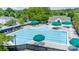 Expansive pool with lap lanes and multiple lounge areas for relaxing in the sun with green umbrellas at 19539 Denae Lynn Dr, Cornelius, NC 28031