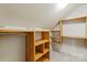Well-organized walk-in closet with wooden shelving, offering plenty of storage space at 1974 Glen Manor Ct, Lincolnton, NC 28092