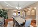 Dining room with hardwood floors, a chandelier, and an arched doorway leading to the living room at 1974 Glen Manor Ct, Lincolnton, NC 28092