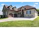 Charming stone and brick home with a two-car garage, arched entrance, and well-maintained landscaping at 1974 Glen Manor Ct, Lincolnton, NC 28092
