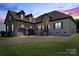 Stunning stone and brick home featuring a two-car garage, arched entrance, and well-manicured lawn at 1974 Glen Manor Ct, Lincolnton, NC 28092