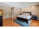 Main bedroom featuring tray ceiling, hardwood flooring, and a cozy, inviting atmosphere at 1974 Glen Manor Ct, Lincolnton, NC 28092
