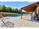 Relaxing pool area with a covered patio, perfect for outdoor entertaining and enjoying the summer weather at 1974 Glen Manor Ct, Lincolnton, NC 28092