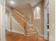 Beautiful wooden staircase with hardwood floors and recessed wall lighting, showcasing the home's craftsmanship at 1974 Glen Manor Ct, Lincolnton, NC 28092