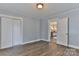 Spacious bedroom featuring hardwood floors, soft blue walls, and open closet with an interior door at 2126 Robby Dr, Maiden, NC 28650