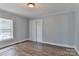 Bright bedroom with hardwood floors, soft-blue walls, and a closet with window views at 2126 Robby Dr, Maiden, NC 28650