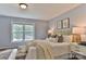 Bright bedroom with light-blue walls, plush bedding, and natural light streaming in through a large window at 2126 Robby Dr, Maiden, NC 28650