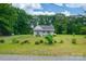 Distant house view with lush surrounding greenery, ample yard space, and natural light at 2126 Robby Dr, Maiden, NC 28650