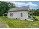 Quaint home featuring a covered porch with seating, surrounded by a green lawn and lush trees at 2126 Robby Dr, Maiden, NC 28650