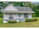 Charming home with a covered front porch, seating, and mature landscaping at 2126 Robby Dr, Maiden, NC 28650
