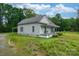 Exterior shot of a charming house with a covered front porch surrounded by lush greenery at 2126 Robby Dr, Maiden, NC 28650