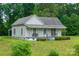 Cozy single-story home featuring a covered front porch with seating area and landscaped front yard at 2126 Robby Dr, Maiden, NC 28650