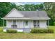 Quaint home with a welcoming covered front porch, chairs, and landscaped bushes at 2126 Robby Dr, Maiden, NC 28650