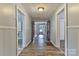 Hallway featuring wood-look floors, paneled walls, and open doorways, creating a welcoming flow throughout the home at 2126 Robby Dr, Maiden, NC 28650