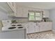 Charming kitchen features bright white cabinets, classic appliances, and double-basin sink under a window at 2126 Robby Dr, Maiden, NC 28650