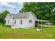 Rear exterior view with covered parking, well, and landscaped yard at 2126 Robby Dr, Maiden, NC 28650