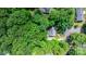 Aerial view of home in green outline surrounded by mature trees at 220 Pinehurst Ln, Newton, NC 28658