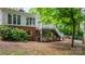 Exterior view of brick home with deck, walk out porch, fenced yard and mature landscaping at 220 Pinehurst Ln, Newton, NC 28658