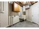 Unfinished basement with utility sink, storage cabinets, and exposed ceiling at 220 Pinehurst Ln, Newton, NC 28658