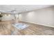 Open basement area with wood-look floors, ceiling fan and decorative rug at 220 Pinehurst Ln, Newton, NC 28658