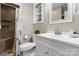 Bright bathroom features a walk-in shower with stone base and built in shelving next to a white vanity at 220 Pinehurst Ln, Newton, NC 28658