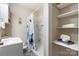 Updated bathroom featuring new tile shower and convenient shelving at 220 Pinehurst Ln, Newton, NC 28658