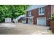 Exterior view of brick home featuring a walk out porch, stairs to deck, garage and shed at 220 Pinehurst Ln, Newton, NC 28658