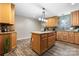 Eat-in kitchen with a center island, wooden cabinets and stainless steel appliances at 220 Pinehurst Ln, Newton, NC 28658